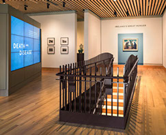 Museum upper gallery, stair railing, media wall